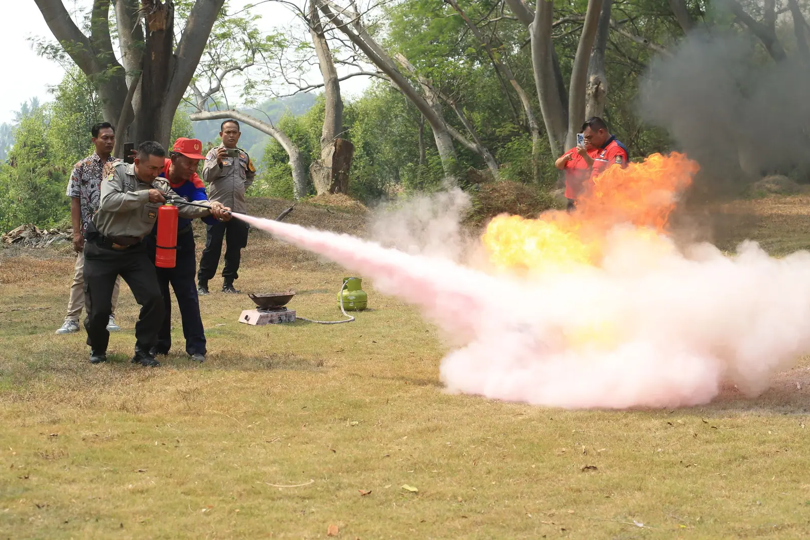 Group during a fire extinguisher training exercise outdoors